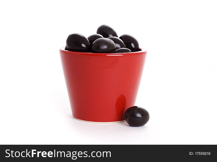 Bowl of black olives isolated on white background