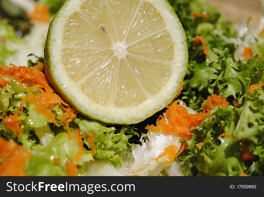 Lemon in dish of vegetable salad, citrus to prepare vegetables to eat.