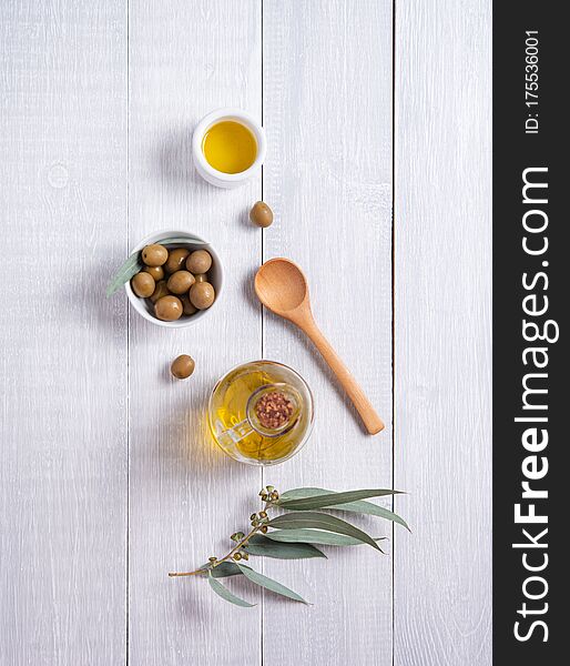 Ripe Natural Eco Friendly Olives With Olive Oil In A Bottle On A White Wooden Background