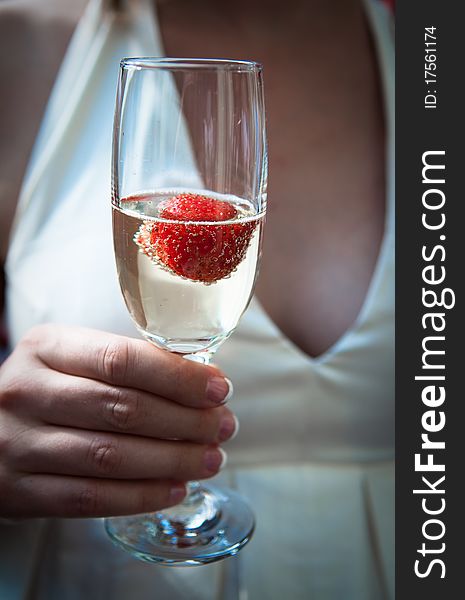 Bust of young bride in white dress toasting with champagne. Bust of young bride in white dress toasting with champagne