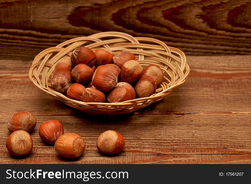 Wood nuts in a basket on wood background