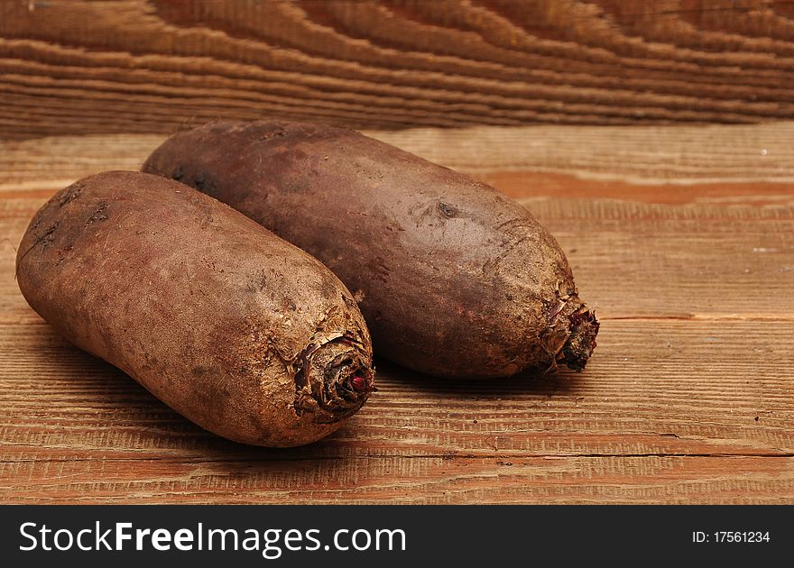 Two beetroot on wood background