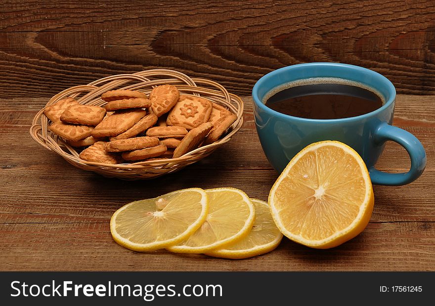 Cup Of Tea With Lemon And Cookies In Basket