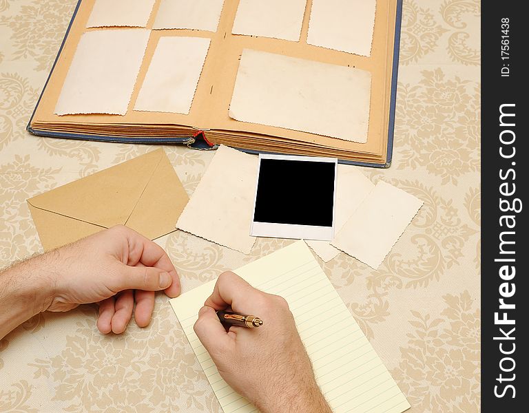 Male hands write letter on table. Male hands write letter on table