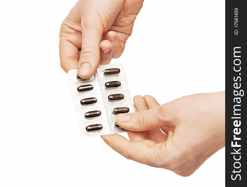 Woman holding pills. Isolated on a white background.