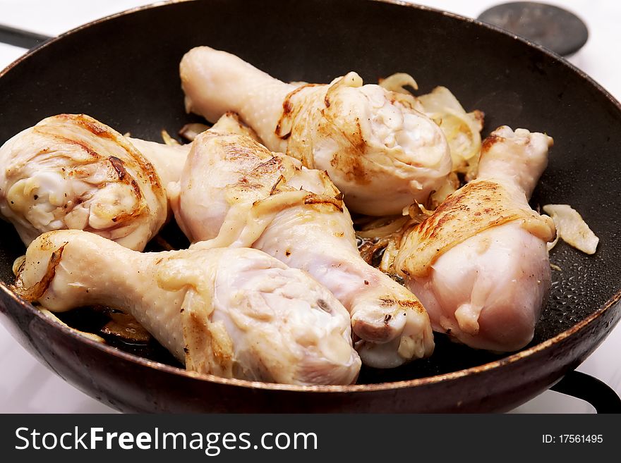 Fried chicken legs in a frying pan. Fried chicken legs in a frying pan