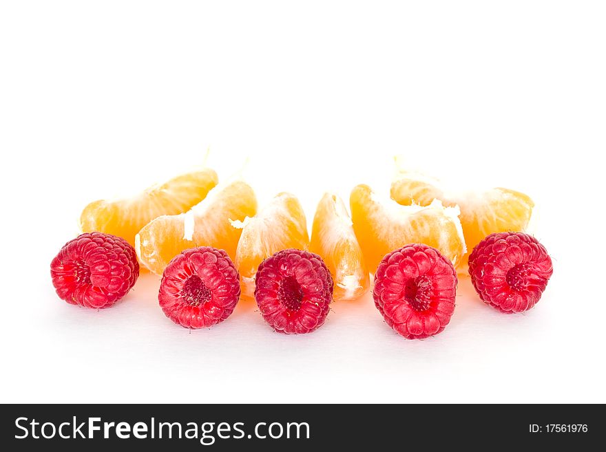 Raspberries and tangerines isolated on white