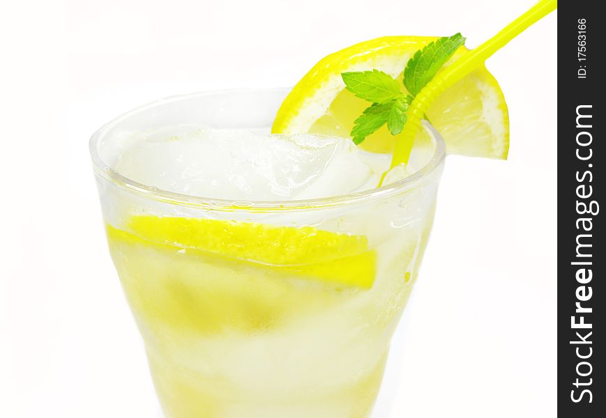 Glass of fruit yellow lemonade with ice lemon and mint. Glass of fruit yellow lemonade with ice lemon and mint