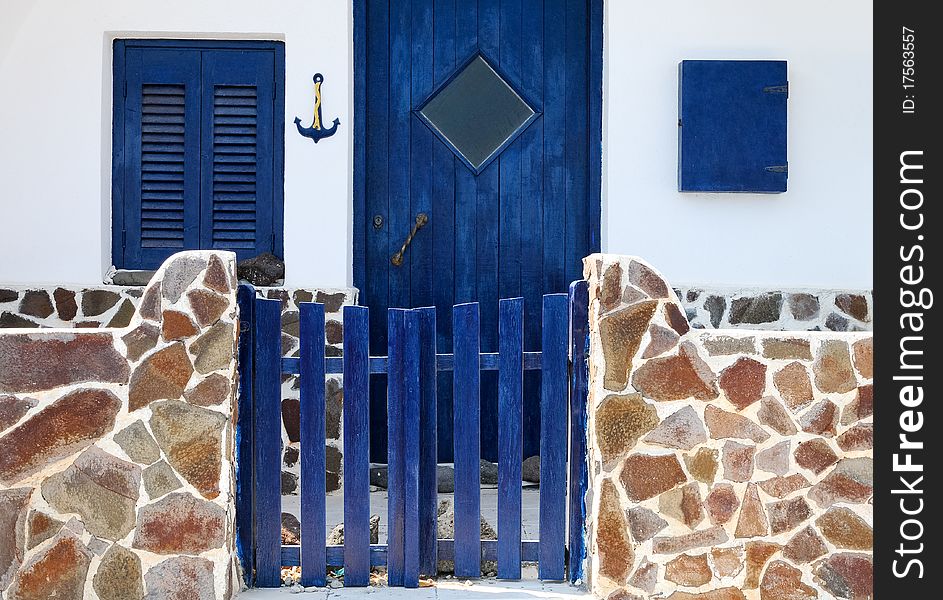 Exterior of a traditional house in Santorini Island, with the blue and white as the major colors. Exterior of a traditional house in Santorini Island, with the blue and white as the major colors