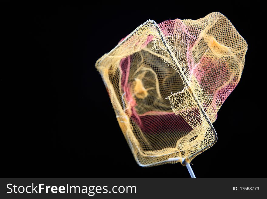 Closeup shot of fish net isolated on black ground.