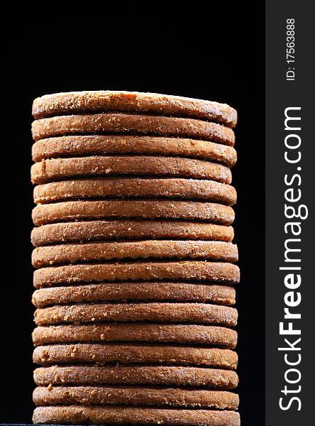 Cookies pile isolated on black background.