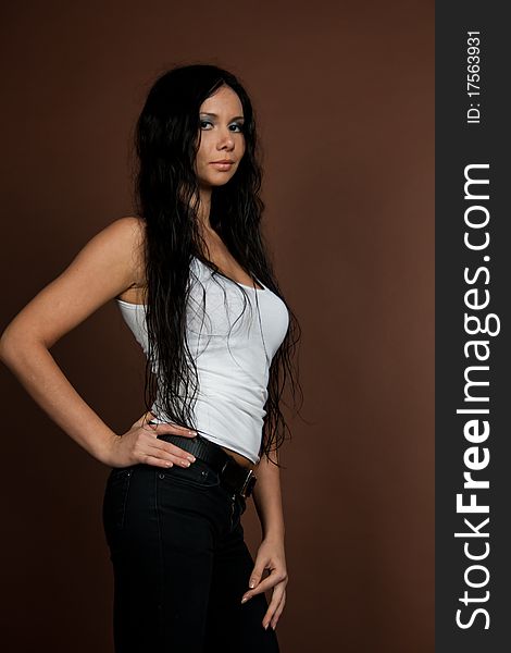 glamorous girl with wet hair in white T-shirt isolated on brown background. glamorous girl with wet hair in white T-shirt isolated on brown background