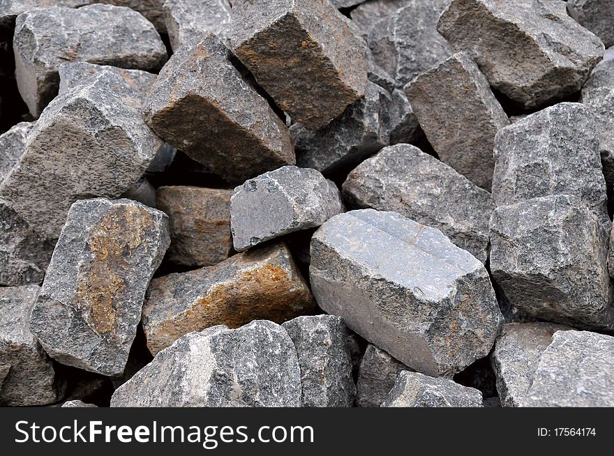 Pile of natural gray stone bricks closeup