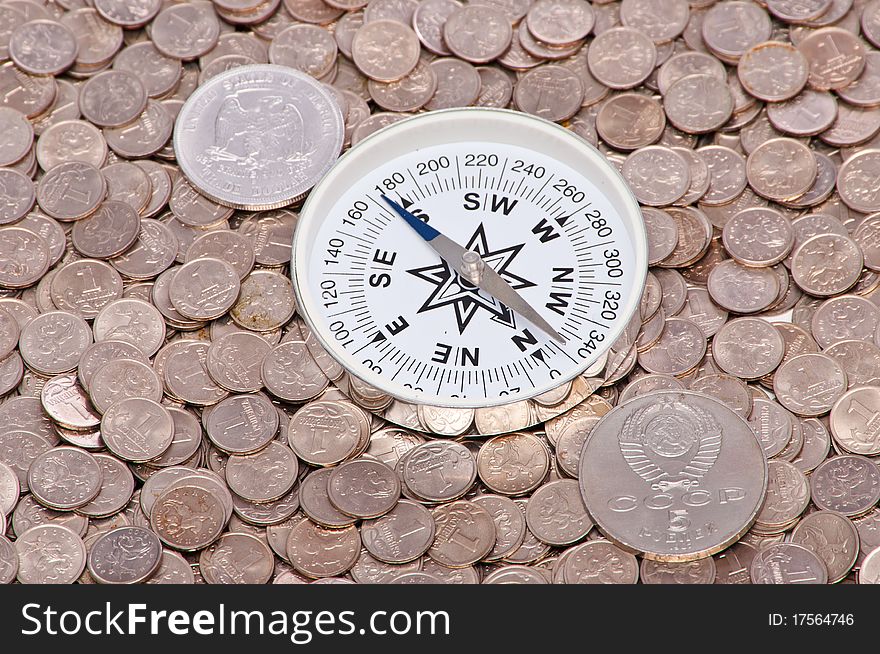 Two coins of the different states and compass. Two coins of the different states and compass