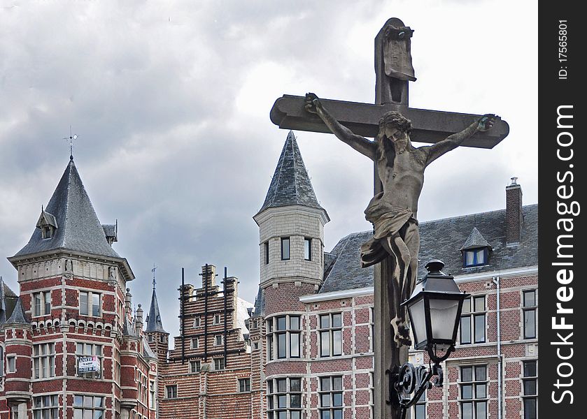 Statue of Jesus - Crucifixion against ancient buildings in Antwerp. Statue of Jesus - Crucifixion against ancient buildings in Antwerp