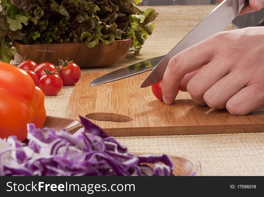 Chef Man cut vegetables on kitchen blackboard.