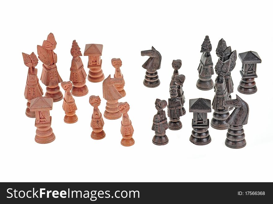 Wood Craved Chess Pieces Arranged On A White Background