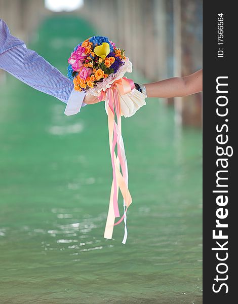 Two Hand Holding Beautiful Flower Bouquet