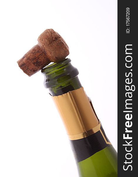 Champagne bottle and cork  on a plain white background.