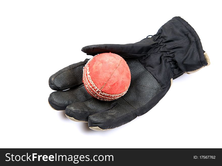 Leather cricket ball over leather glove isolated on white background. Leather cricket ball over leather glove isolated on white background.