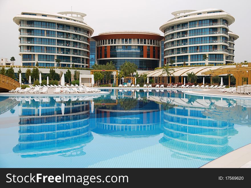 Luxury hotel with reflection in the pool. Turkey, Antalia.