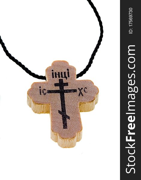 The isolated wooden cross on which the cross and religious words is drawn