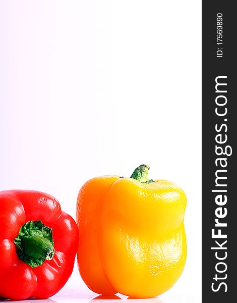 Red and yellow peppers on a white background