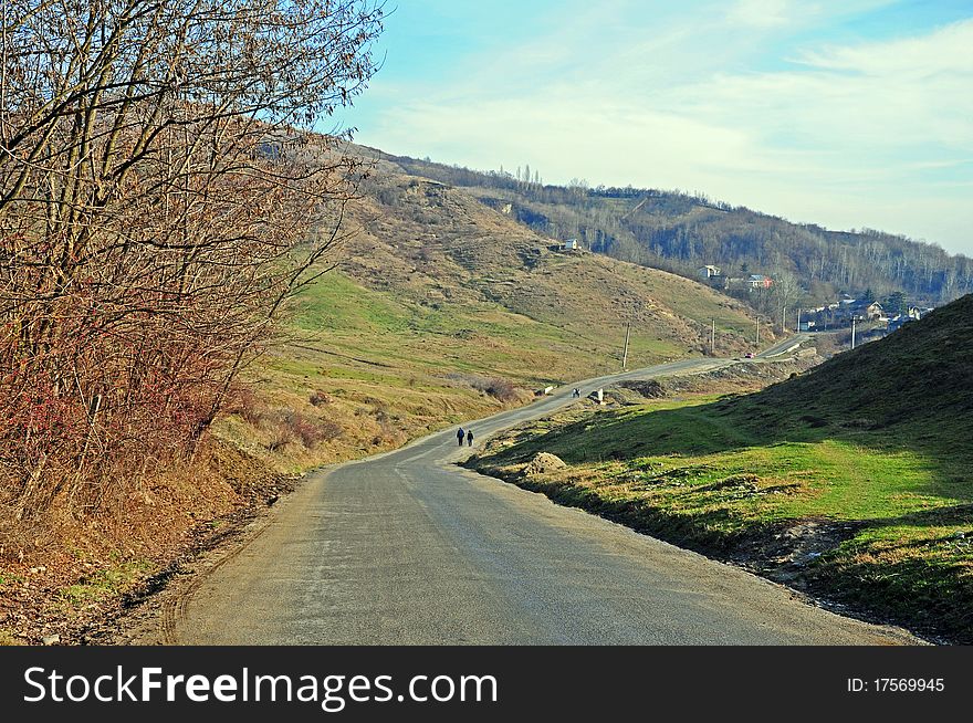 Curved road on hills in sunny day