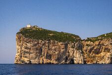Alghero, Sardinia, Italy - Faro Di Capo Caccia Lighthouse At The Limestone Cliffs Of The Capo Caccia Cape At The Gulf Of Alghero Stock Images