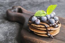 Chocolate Pancakes With Chocolate Syrup. On A Wooden Board Stock Photo