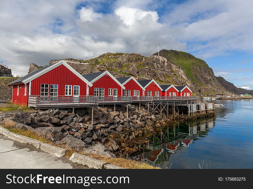 Typical Norwegian fishing village with traditional red rorbu huts, Reine, Lofoten Islands, Norway. Typical Norwegian fishing village with traditional red rorbu huts, Reine, Lofoten Islands, Norway