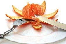 Cleared Mandarine On A Plate, Plug, Knife. Royalty Free Stock Photos Cleared Mandarine On A Plate, Plug, Knife. Royalty Free Stock Photos