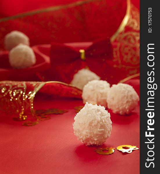 Arrangement of coconut cookies on red elegant background.