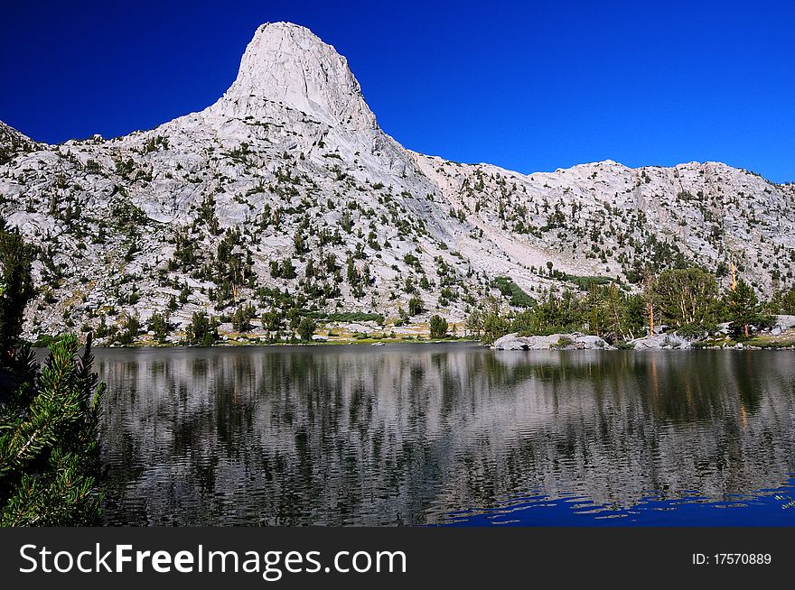 A picture of Fin Dome with its reflection across the lake underneath. A picture of Fin Dome with its reflection across the lake underneath