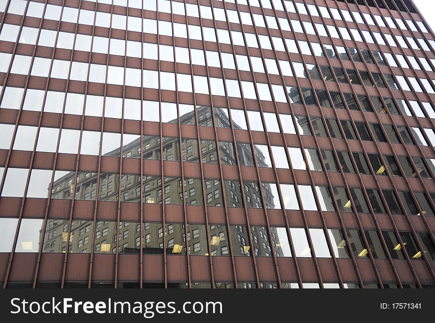 Reflection of large buildings in glass windows of another modern building. Reflection of large buildings in glass windows of another modern building