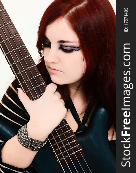 Beautiful 19 year old girl with 5 string electric bass guitar. Beautiful 19 year old girl with 5 string electric bass guitar.