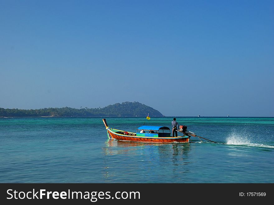 Long-tail boat sails through Andaman sea
