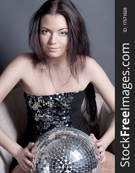 Beautiful young girl in charming dress with disco ball. Beautiful young girl in charming dress with disco ball