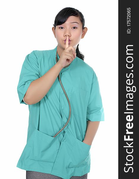 A Doctor wearing scrub say silent please isolated over white background. A Doctor wearing scrub say silent please isolated over white background