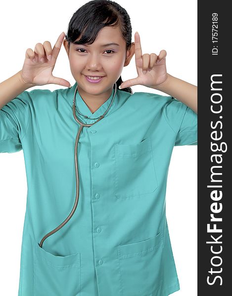 A Doctor wearing scrub framing her face isolated over white background. A Doctor wearing scrub framing her face isolated over white background