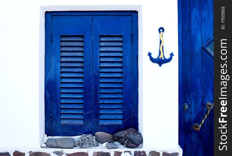 Exterior of a traditional house in Santorini Island, with the blue and white as the major colors. Exterior of a traditional house in Santorini Island, with the blue and white as the major colors
