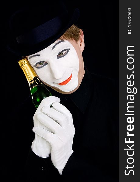 Portrait of a dreaming mime with bottle of champagne
