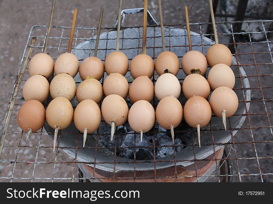 Eggs on a stick being barbecued at an open market in Tha Li, Thailand. Eggs on a stick being barbecued at an open market in Tha Li, Thailand