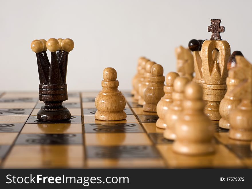 Figures of chess on the chessboard on the white background. Figures of chess on the chessboard on the white background