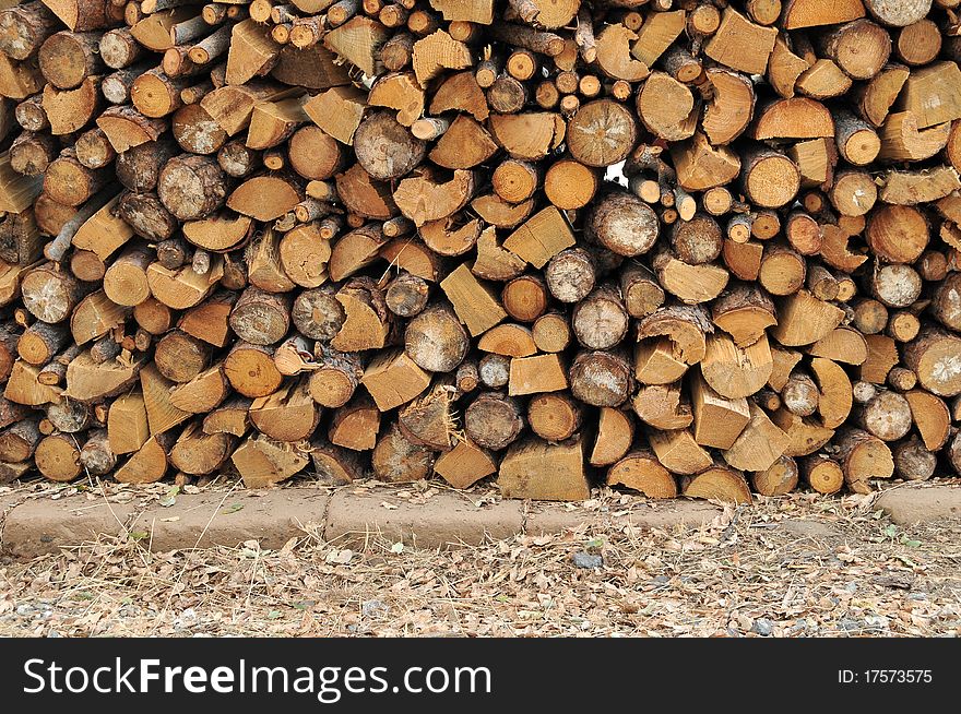 Logs of firewood in a nice stack, all piled up together.