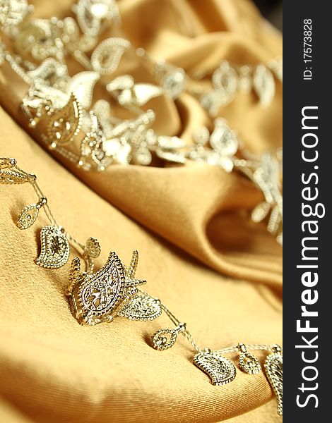 Background of gold cloth on which lay the golden jewelry. Background of gold cloth on which lay the golden jewelry