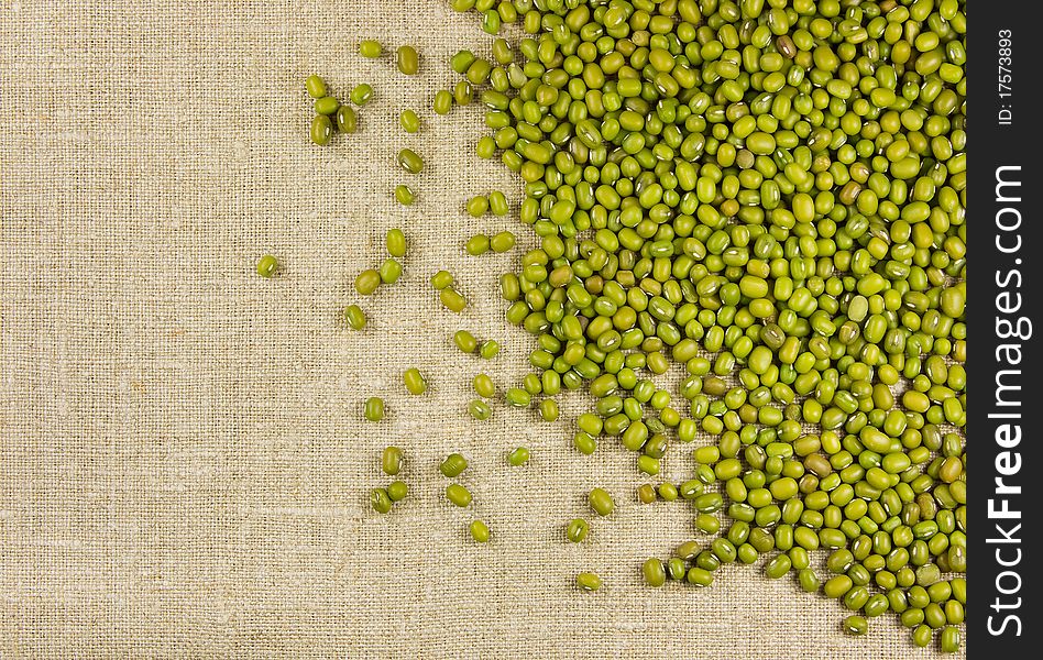 Green mung beans on the burlap background