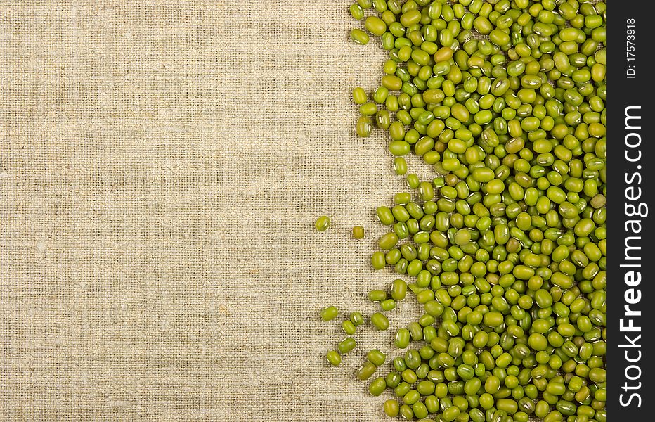 Green mung beans on the burlap background