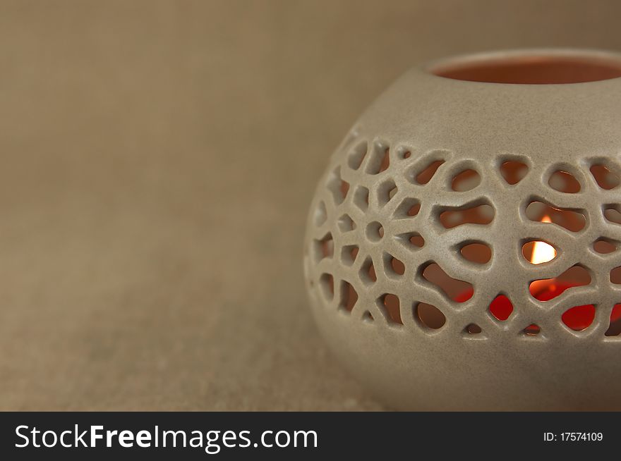 Ceramic aroma lamp on the burlap background