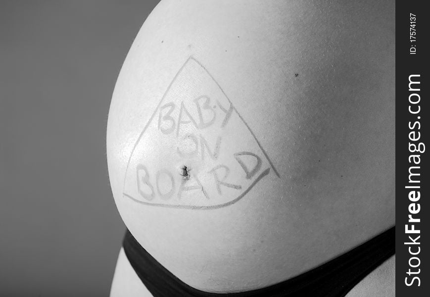 Expectant mother with writing baby on board